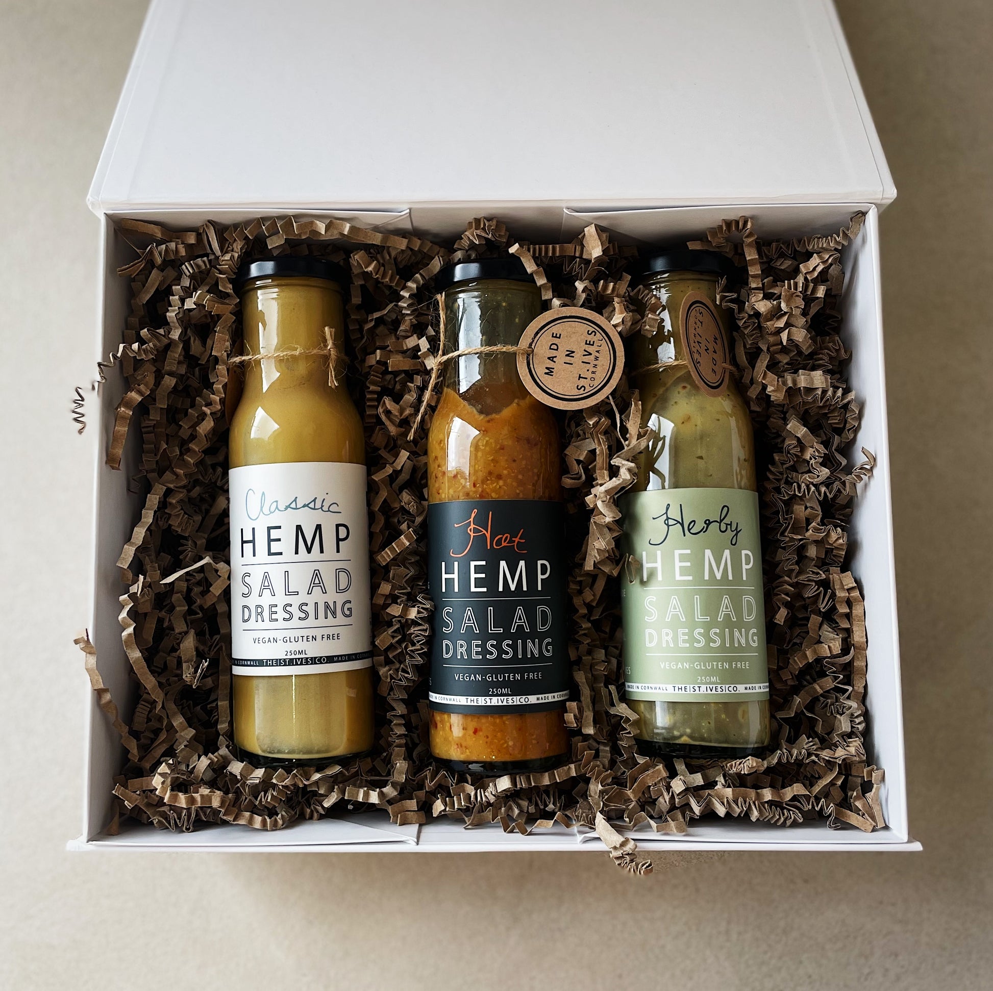 Large quality white hamper box filled with 3 Hemp salad dressings made in st ives Cornwall. Artisan product.